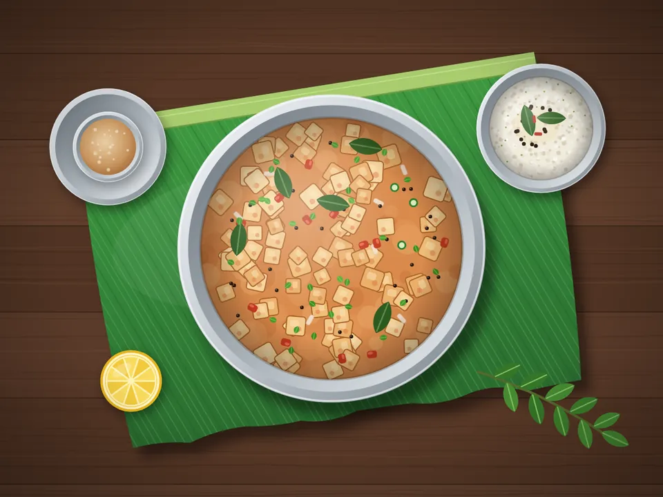 Bread upma with golden bread cubes, tomato and curry leaves in a bowl on a banana leaf